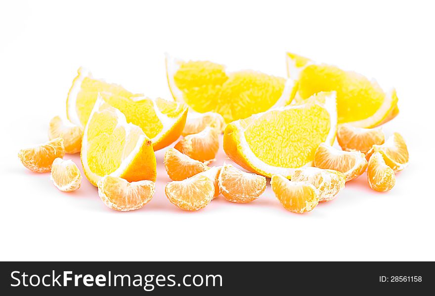 Mandarin and orange on a white background, fruit slices, shallow depth of field. Mandarin and orange on a white background, fruit slices, shallow depth of field