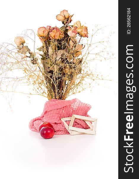 Vase with dry flowers and apples isolated