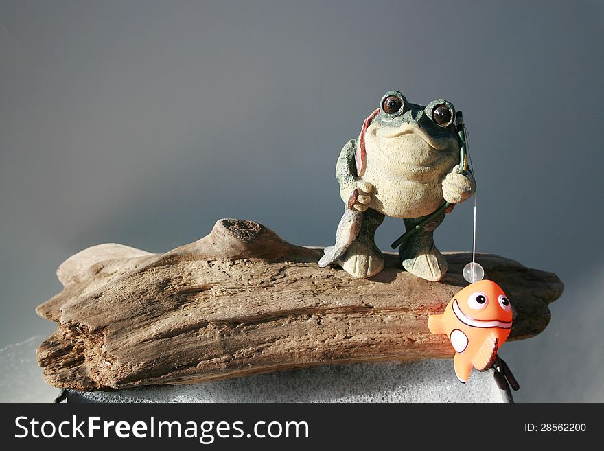 Ceramic frog fishing in a bucket of suds. Ceramic frog fishing in a bucket of suds.