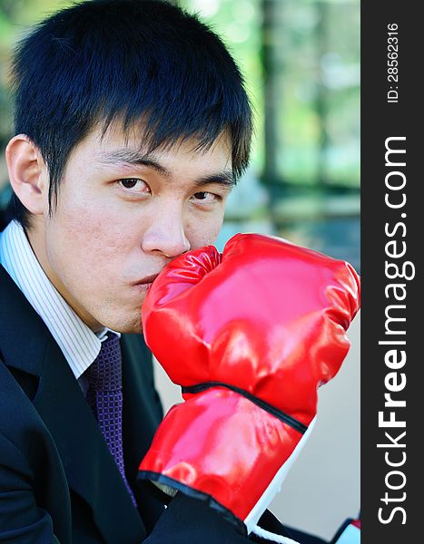 Close up businessman and hand boxing glove ready to fight. Close up businessman and hand boxing glove ready to fight.