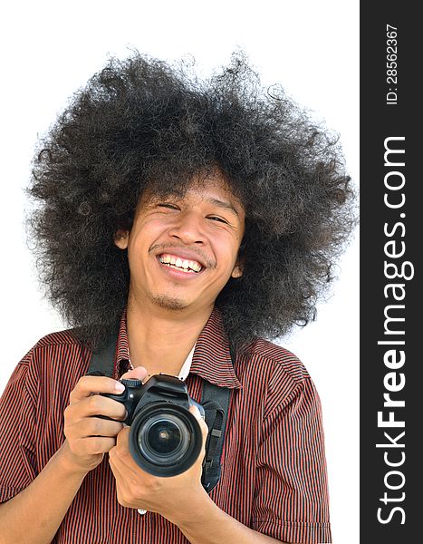 Smiling young man with long hair and holding digital camera. Smiling young man with long hair and holding digital camera