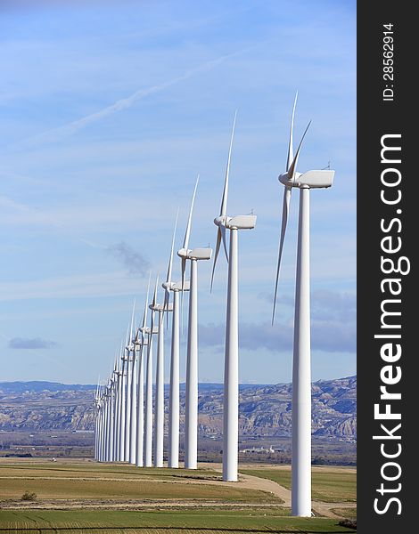 Aligned windmills for renewable electric energy production. Aligned windmills for renewable electric energy production