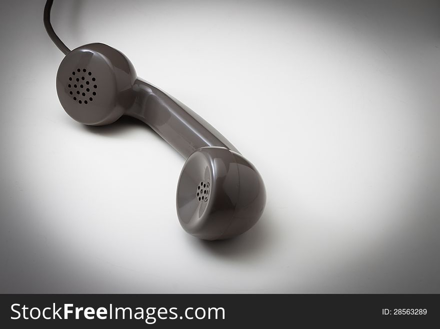 Vintage telephone receiver on a white surface