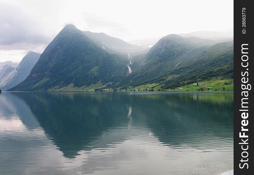 Typical Fjord and mountains with beautiful reflection in the water Norway. Typical Fjord and mountains with beautiful reflection in the water Norway