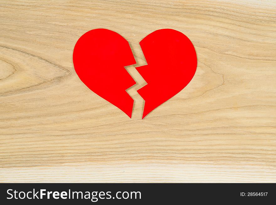 Beautiful broken heart on the background of wood