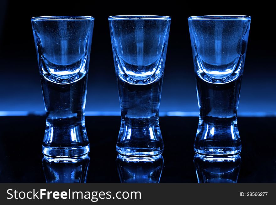 Three shot glasses in blue.