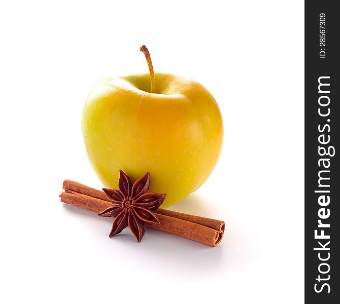 Yellow Apple with Cinnamon Stick and Anise on the White Background