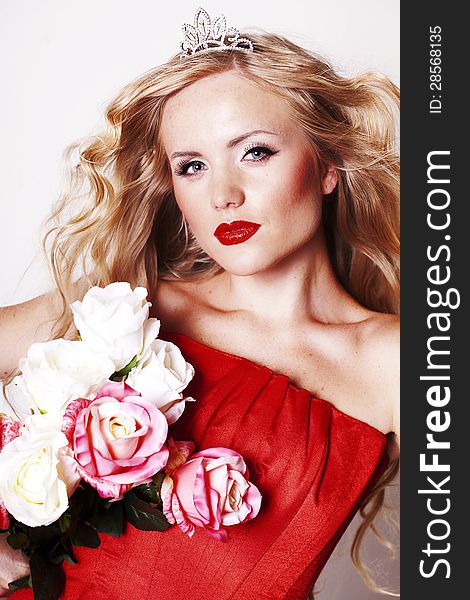 Beautiful Fashion Girl with red makeup and Roses. Hairstyle