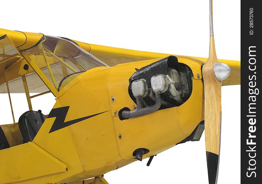 Front close-up of a yellow vintage high wing small aircraft, showing the engine cylinders, propeller, and front cockpit. Isolated on white. Front close-up of a yellow vintage high wing small aircraft, showing the engine cylinders, propeller, and front cockpit. Isolated on white.