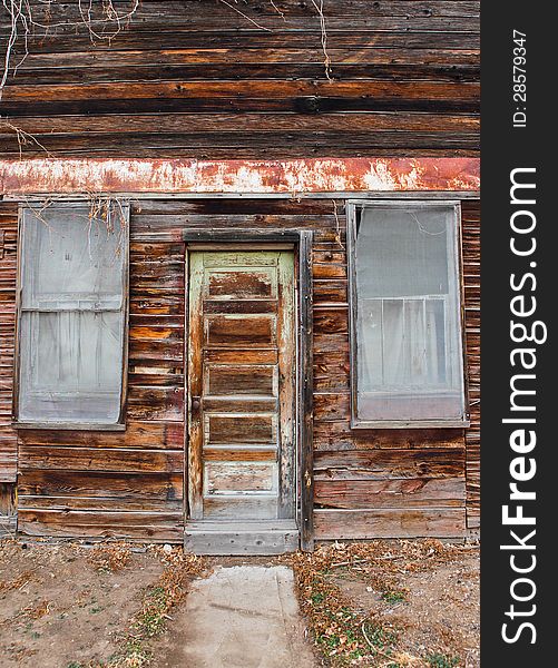 A frontal view of an old grocery store door and windows. A frontal view of an old grocery store door and windows.