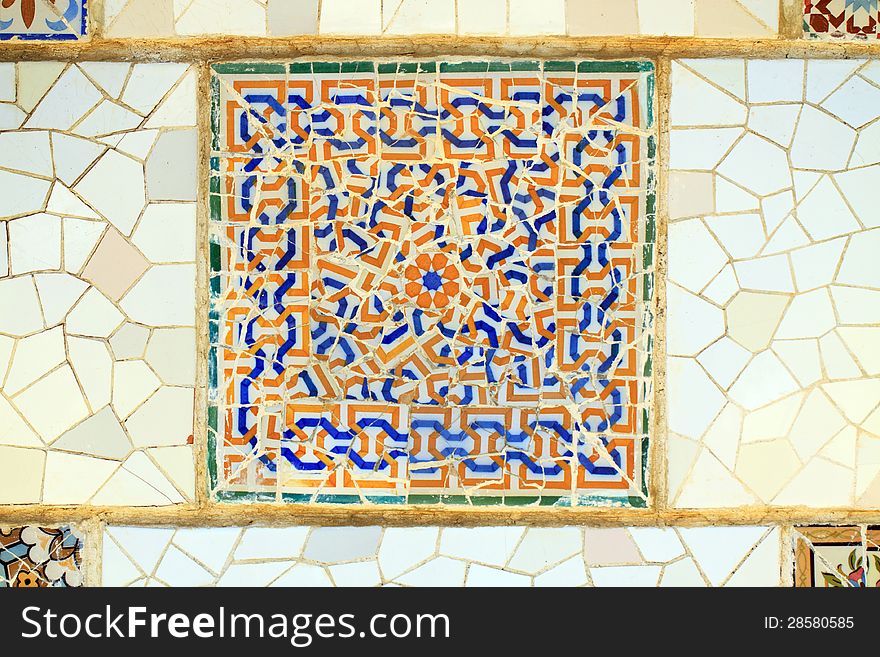 Multicolored Spanish tile, against a white background; in horizontal orientation