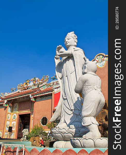 White Guan Yin statue in front of Chinese temple