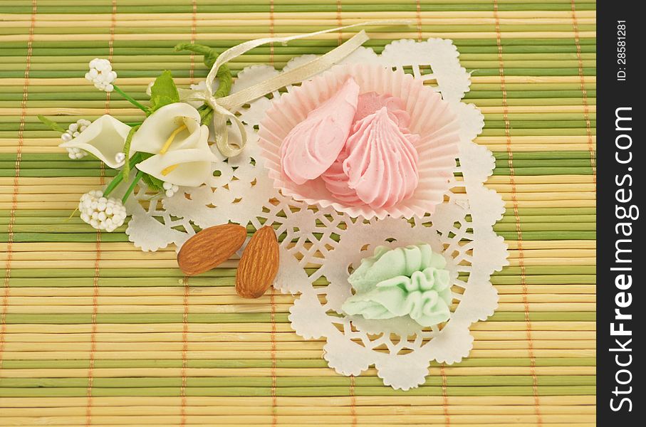 Sweet cream candies with white flowers on the napkin. Sweet cream candies with white flowers on the napkin
