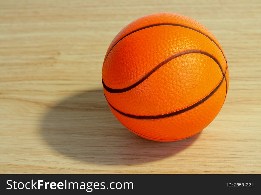 Toy basketball lying on the floor closeup. Toy basketball lying on the floor closeup