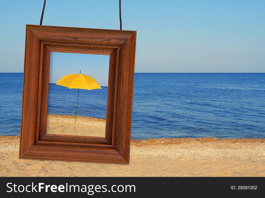 Beach umbrella and photographic frame on the beach