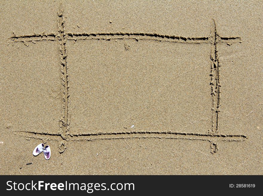 Empty frame drawn on the sand of the sea in summer. Empty frame drawn on the sand of the sea in summer