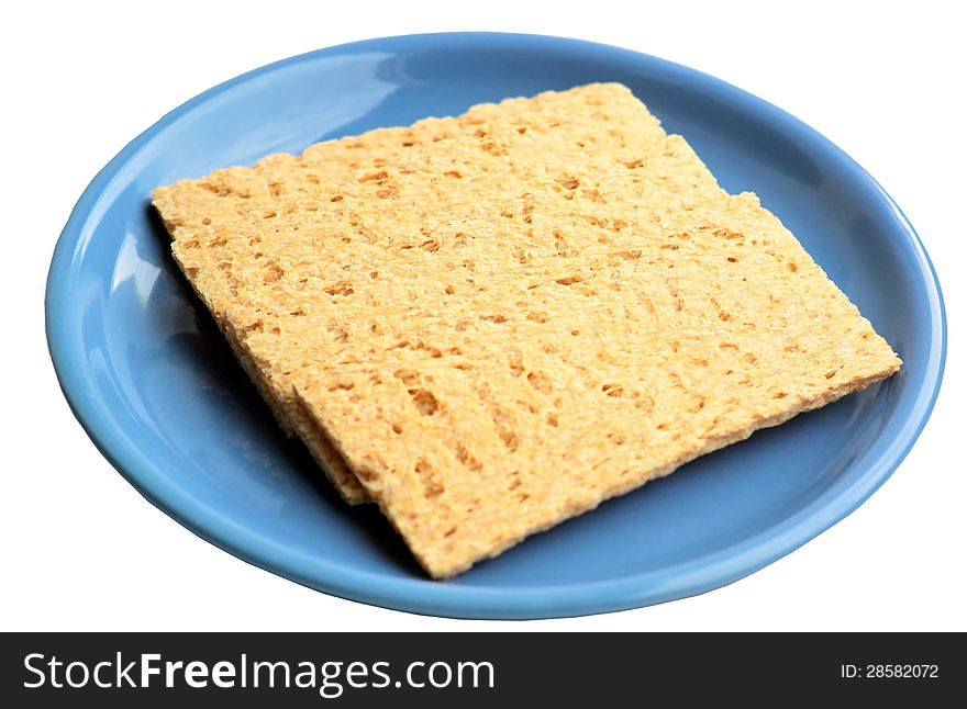 Crackling rye bread on a blue ceramic plate. It is isolated, a white background.