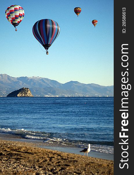 Four hot-air Balloons over Bergeggi, Ligurian Sea, Italy. Four hot-air Balloons over Bergeggi, Ligurian Sea, Italy