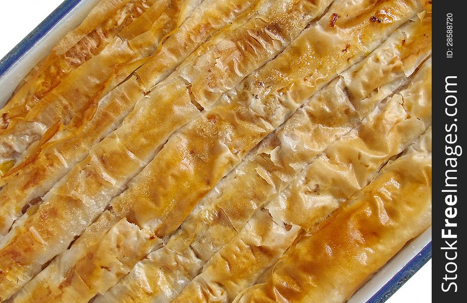 Banitsa is a traditional Bulgarian pastry prepared by layering a mixture of whisked eggs and pieces of pumpkin between filo pastry and then baking it in an oven. Banitsa is a traditional Bulgarian pastry prepared by layering a mixture of whisked eggs and pieces of pumpkin between filo pastry and then baking it in an oven.