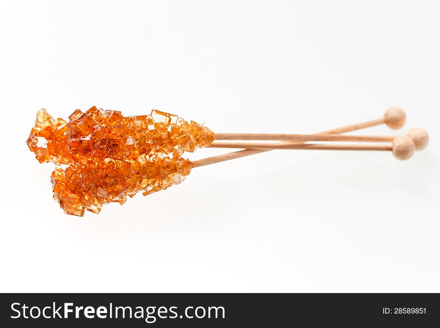 Three rocky candy sugar on a stick over white background