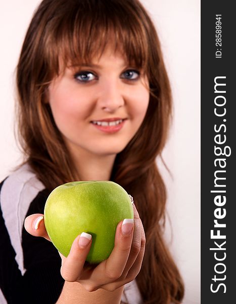 Teen girl shows her green apple. Teen girl shows her green apple.