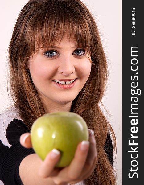 Teen girl shows her green apple. Teen girl shows her green apple.