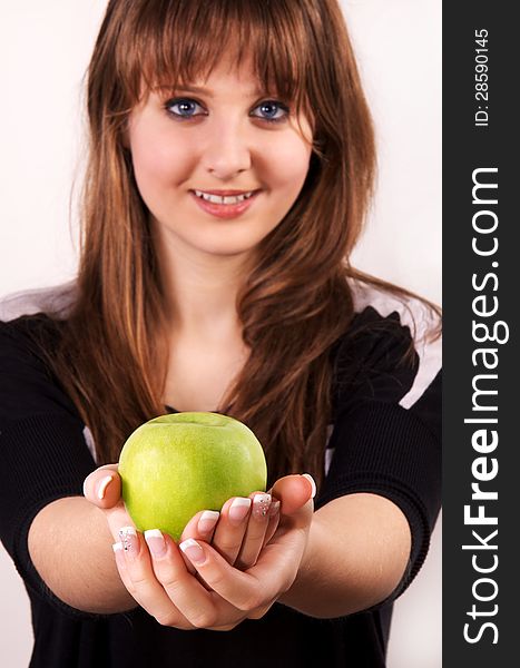 Teen girl shows her green apple. Teen girl shows her green apple.