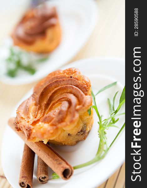 Brown cupcake on a white plate, two