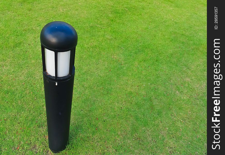 Small lamp post on the green field