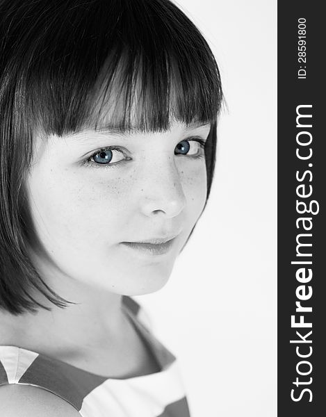 A simple black and white portrait of a pretty young girl with striking blue eyes. A simple black and white portrait of a pretty young girl with striking blue eyes.