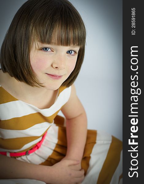 A simple colour portrait of a pretty young girl with striking blue eyes. A simple colour portrait of a pretty young girl with striking blue eyes.