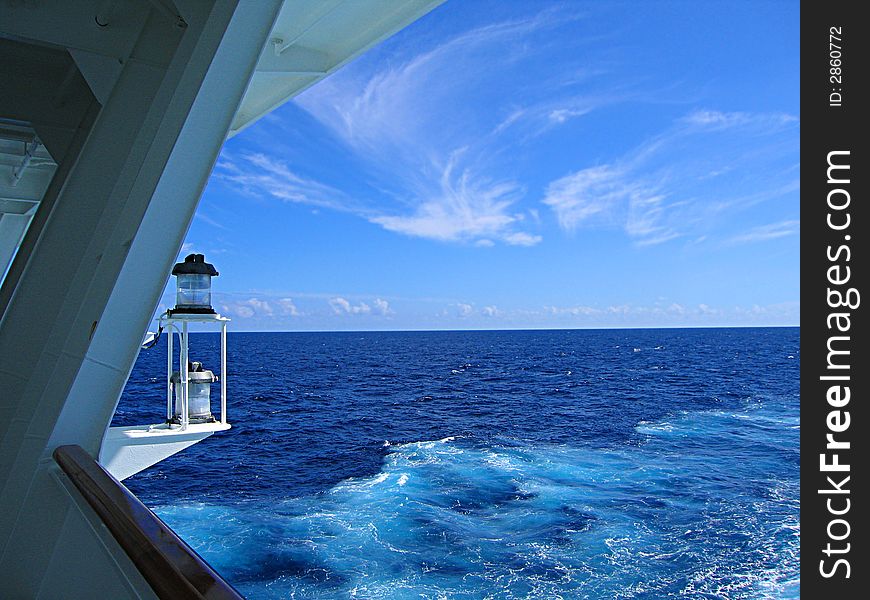 A view of a lantern and an open sea from  the deck
