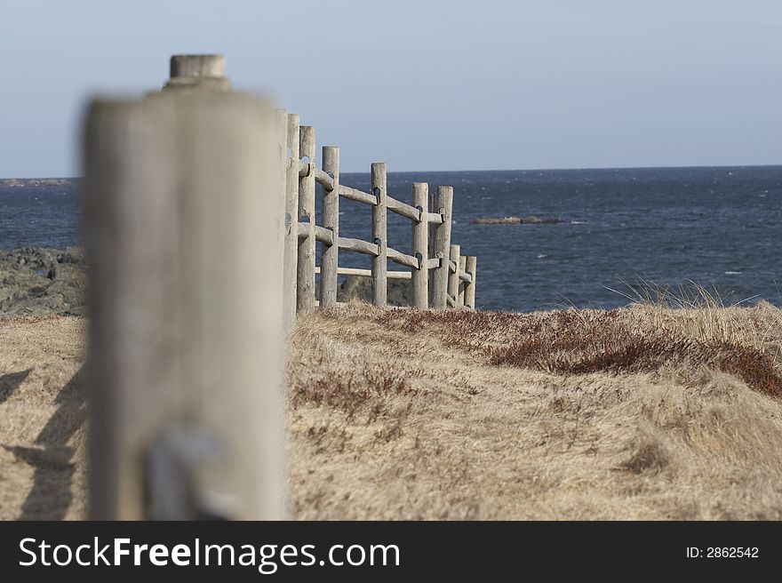 A receding fence along the hills by the ocean.  Taken near Pt. Michaud beach, Cape Breton, Nova Scotia. A receding fence along the hills by the ocean.  Taken near Pt. Michaud beach, Cape Breton, Nova Scotia