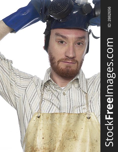 Bearded mand takes off hazardous materials safety mask.  Her is wearing blue rubber gloves and a biege chemistry stained apron. Bearded mand takes off hazardous materials safety mask.  Her is wearing blue rubber gloves and a biege chemistry stained apron.