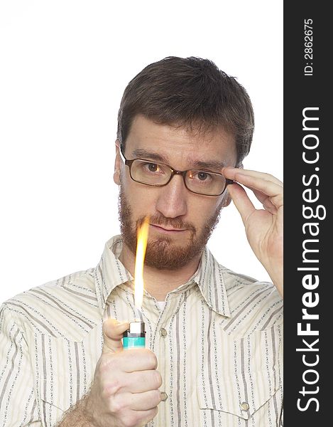 Man with beard turning on a lighter with a large flame against a white background. Man with beard turning on a lighter with a large flame against a white background.