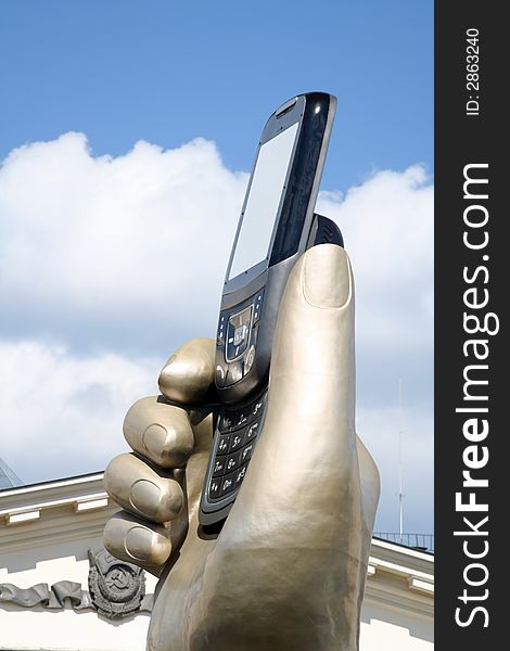 Statue of hand with mobile phone