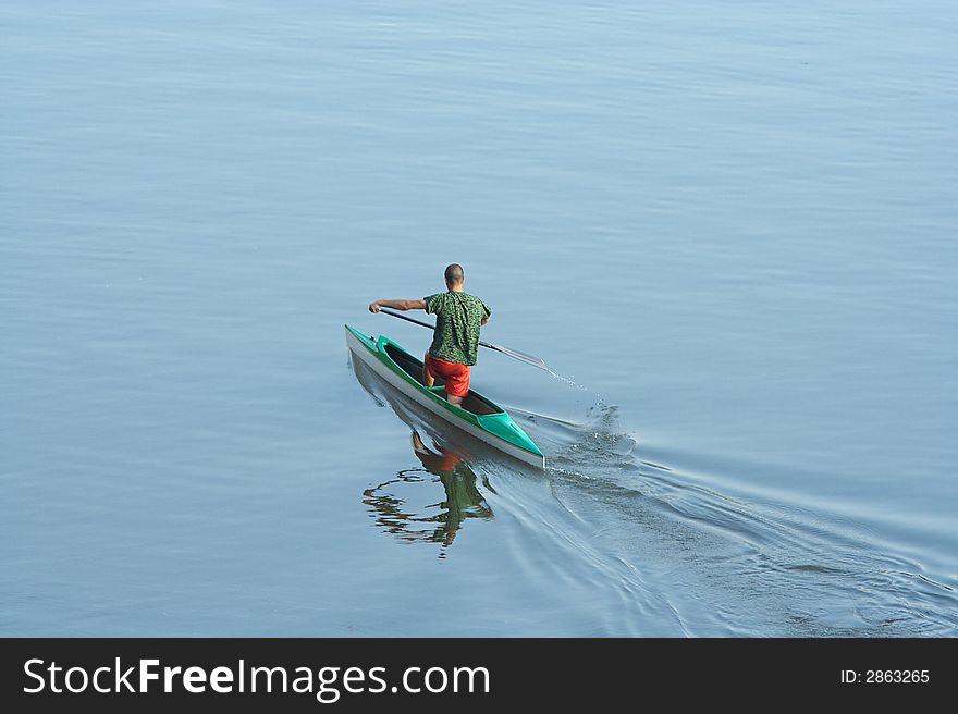 Sportsman rowing in the lake. Sportsman rowing in the lake.