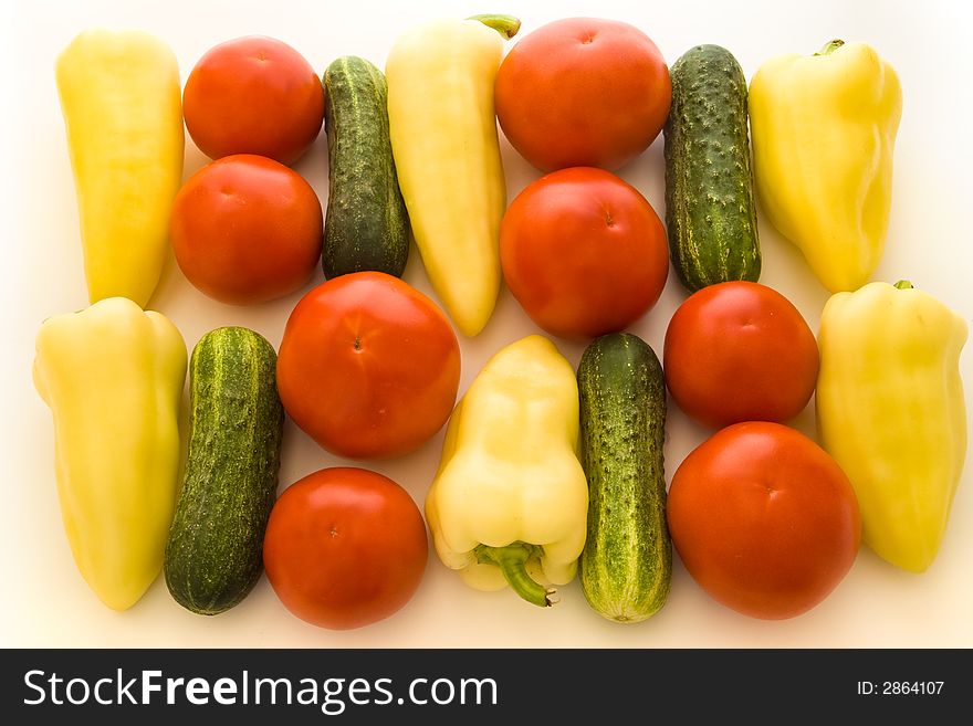 Tomatoes, peppers and cucumbers over white background. Tomatoes, peppers and cucumbers over white background