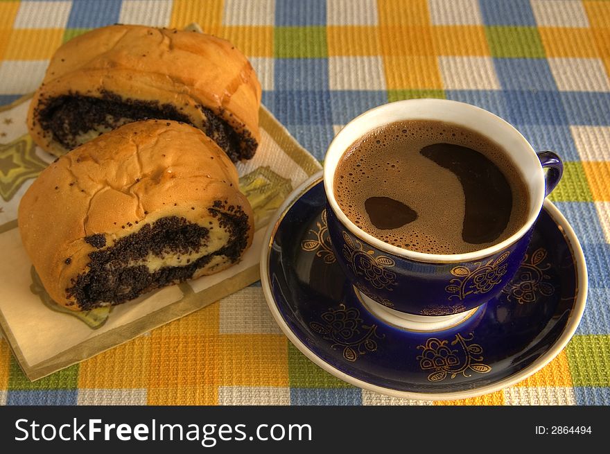 Typical breakfast. Black cofee and roll with poppy-seed. Typical breakfast. Black cofee and roll with poppy-seed