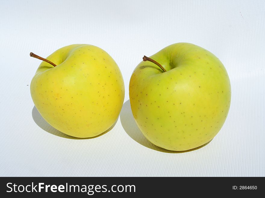 Two yellow apples on white background