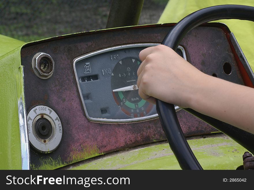 Boy holding a tractor wheel.