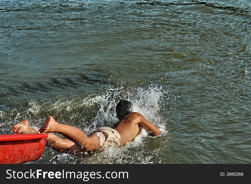 Boy jumpi in the river.