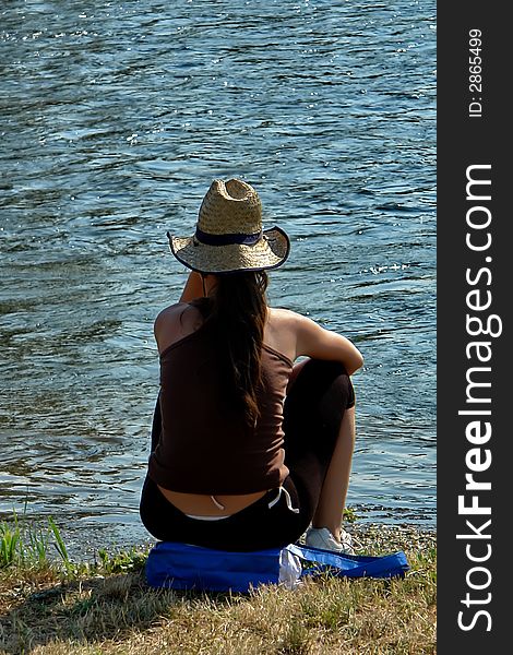 Lonesome girl sit on the river coast. Lonesome girl sit on the river coast.