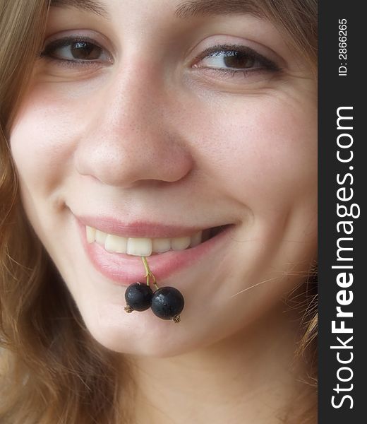 Smiling girl with berries in her teeth. Soft focus. Smiling girl with berries in her teeth. Soft focus