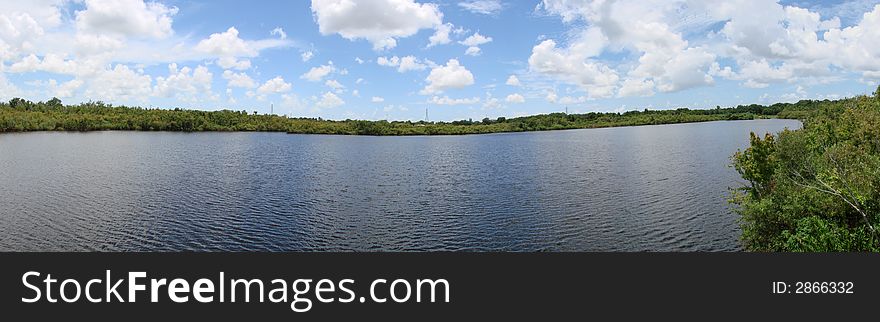 This is a panoramic of sawgrass lake and the sky and clouds. This is a panoramic of sawgrass lake and the sky and clouds