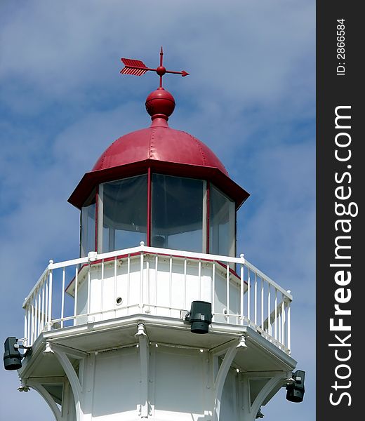 Closeup portrait of lighthouse in blue sky