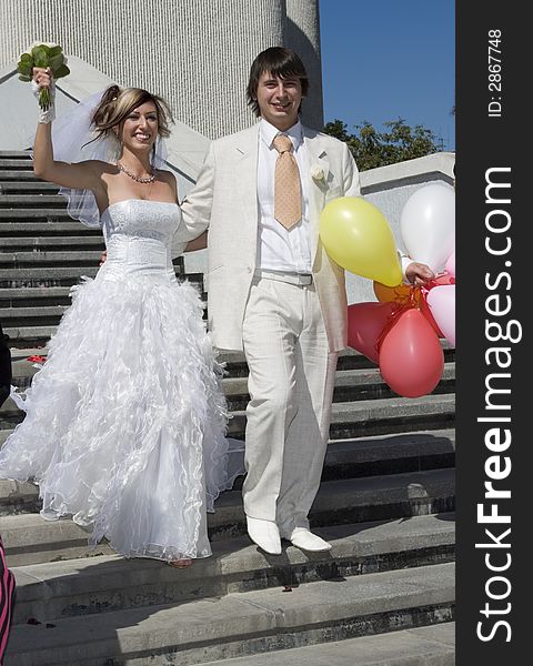 Bride and groom beside roman catholic church