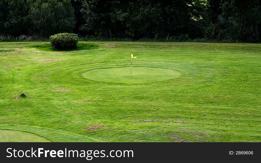 Golf field with yellow flag. Golf field with yellow flag.