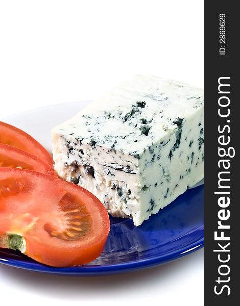 Closeup of blue cheese and tomato slices on the plate.