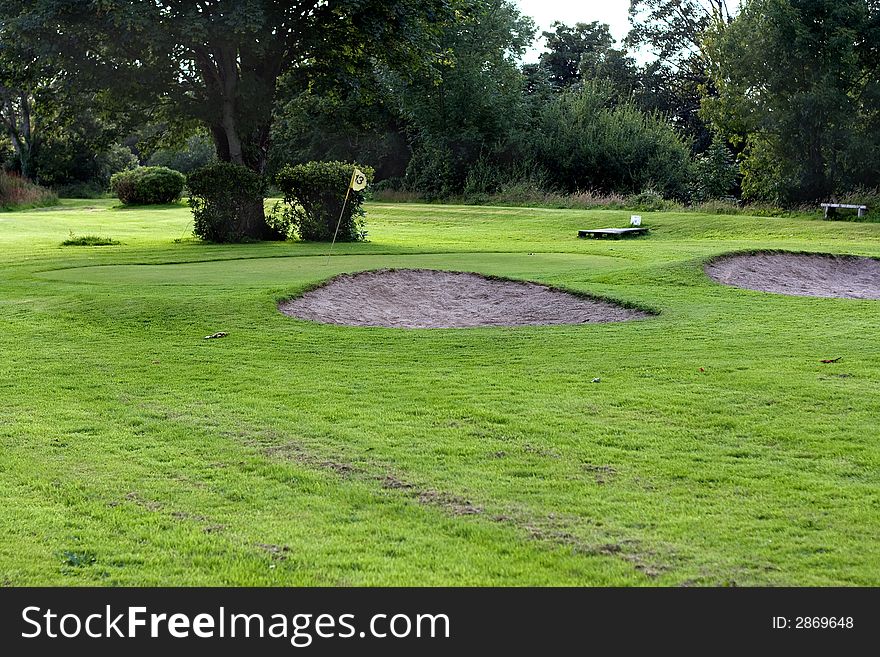 Golf field with yellow flag. Golf field with yellow flag.